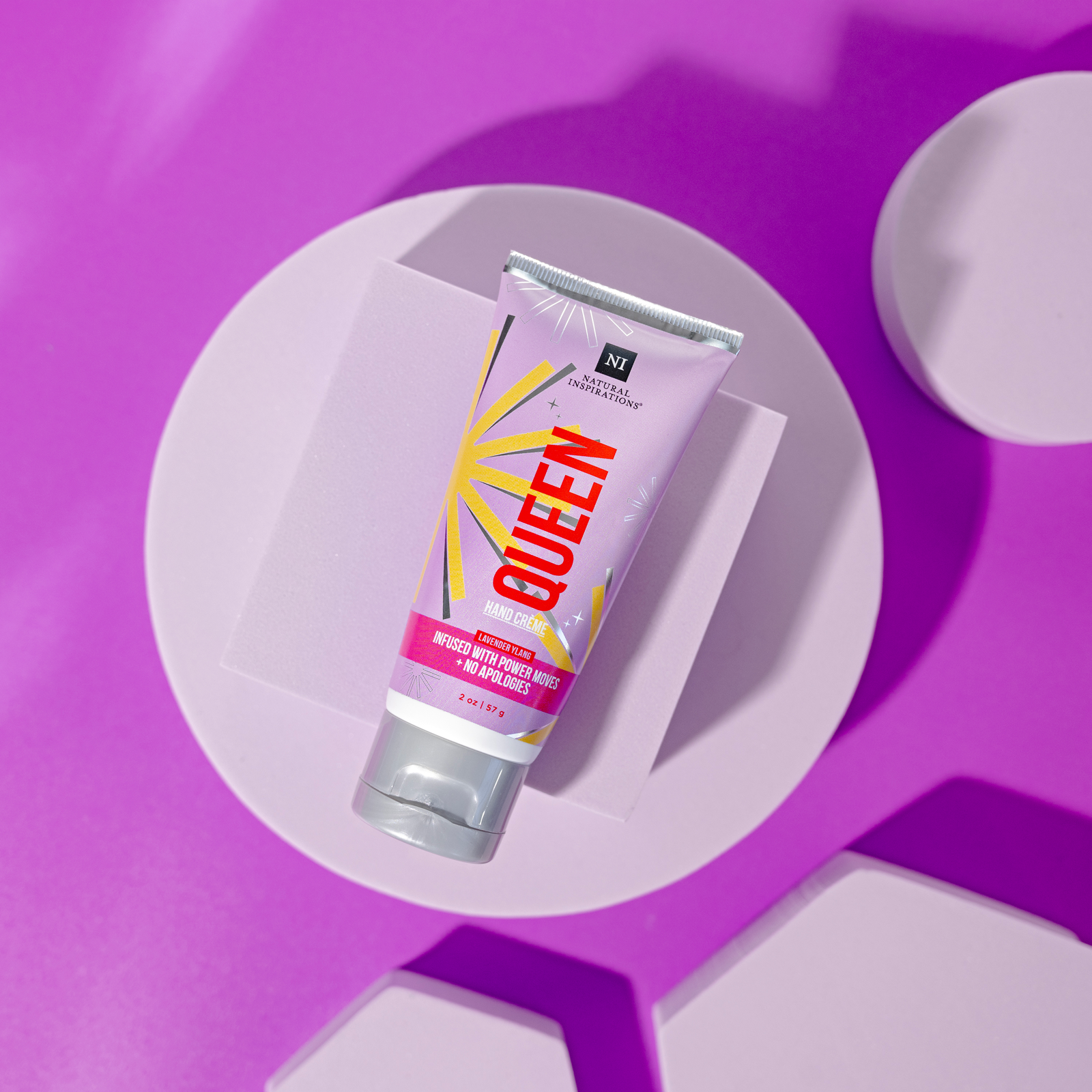 overhead view of queen mini hand cream on a purple background