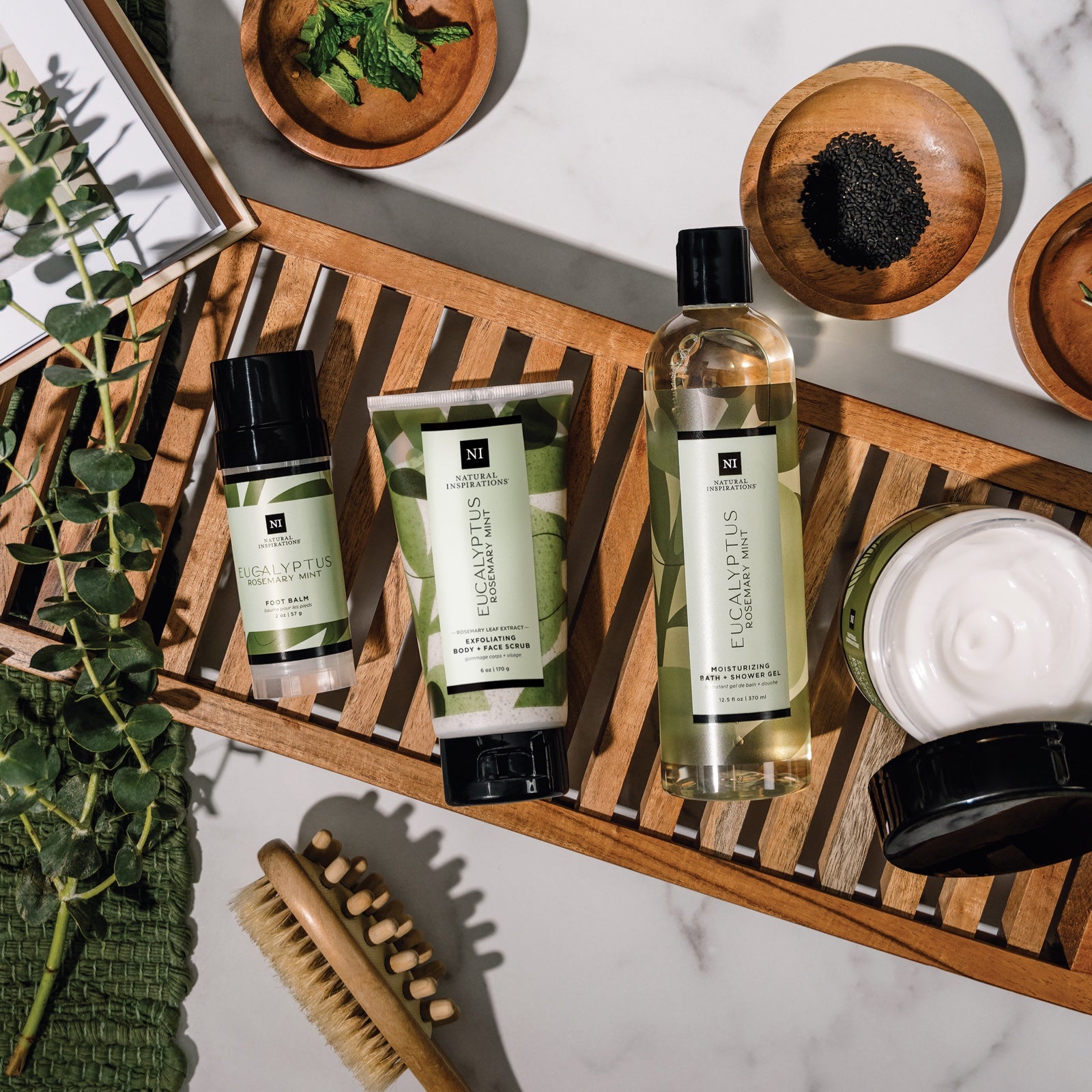 overhead view of eucalyptus rosemary mint products in a bathroom setting