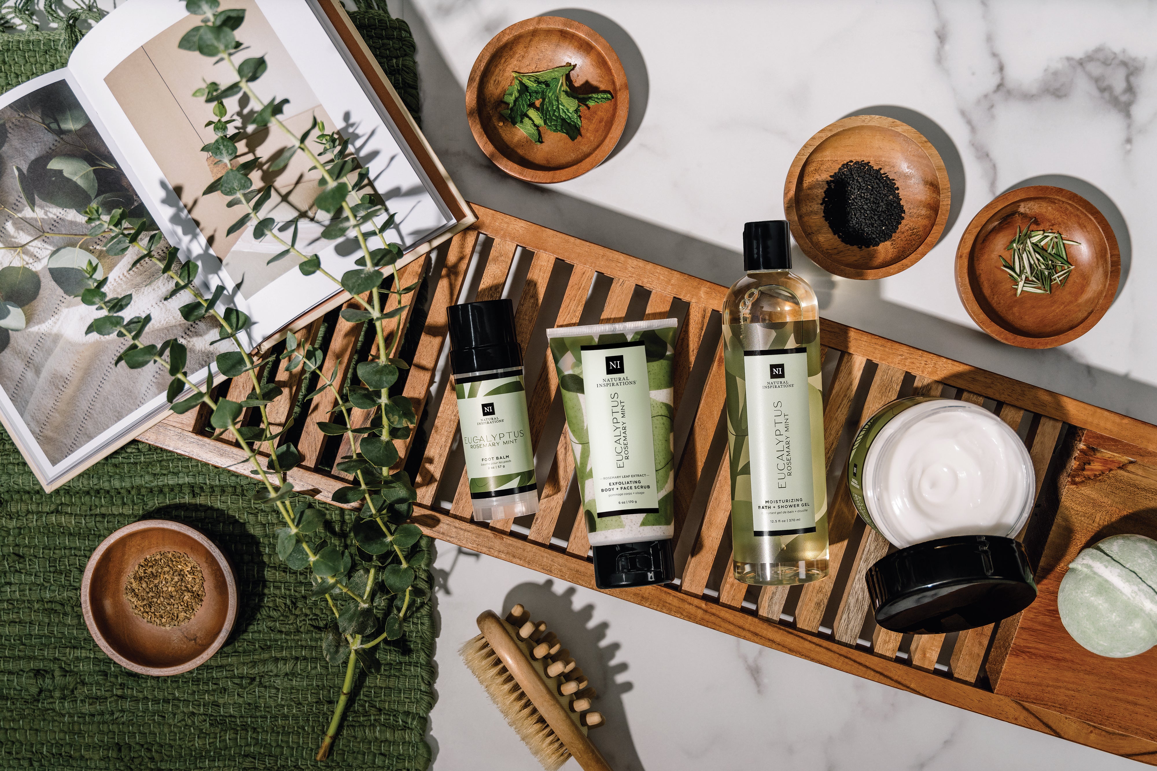 overhead view of eucalyptus rosemary mint products in a bathroom setting