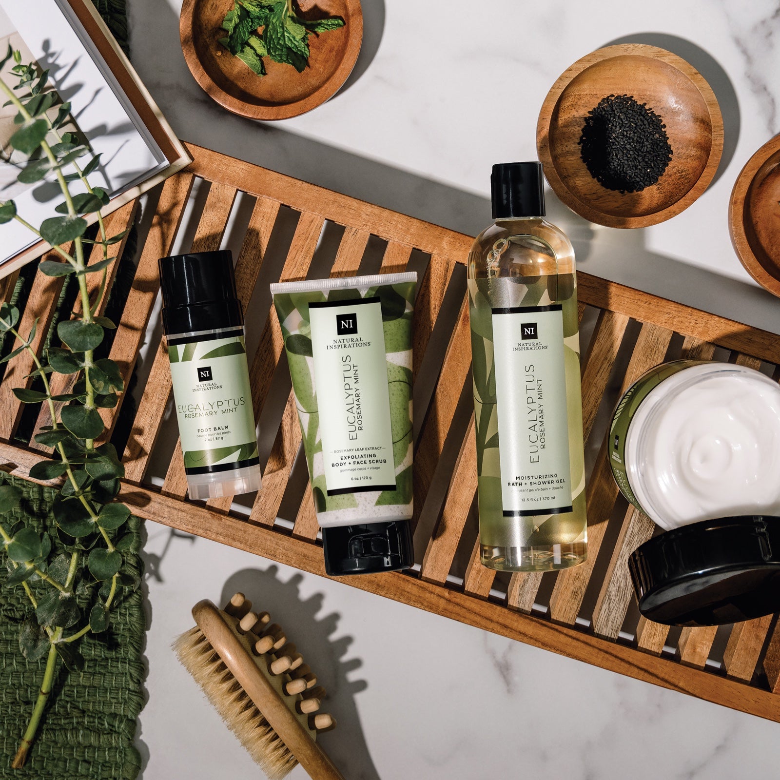 overhead view of eucalyptus rosemary mint products in a bathroom setting