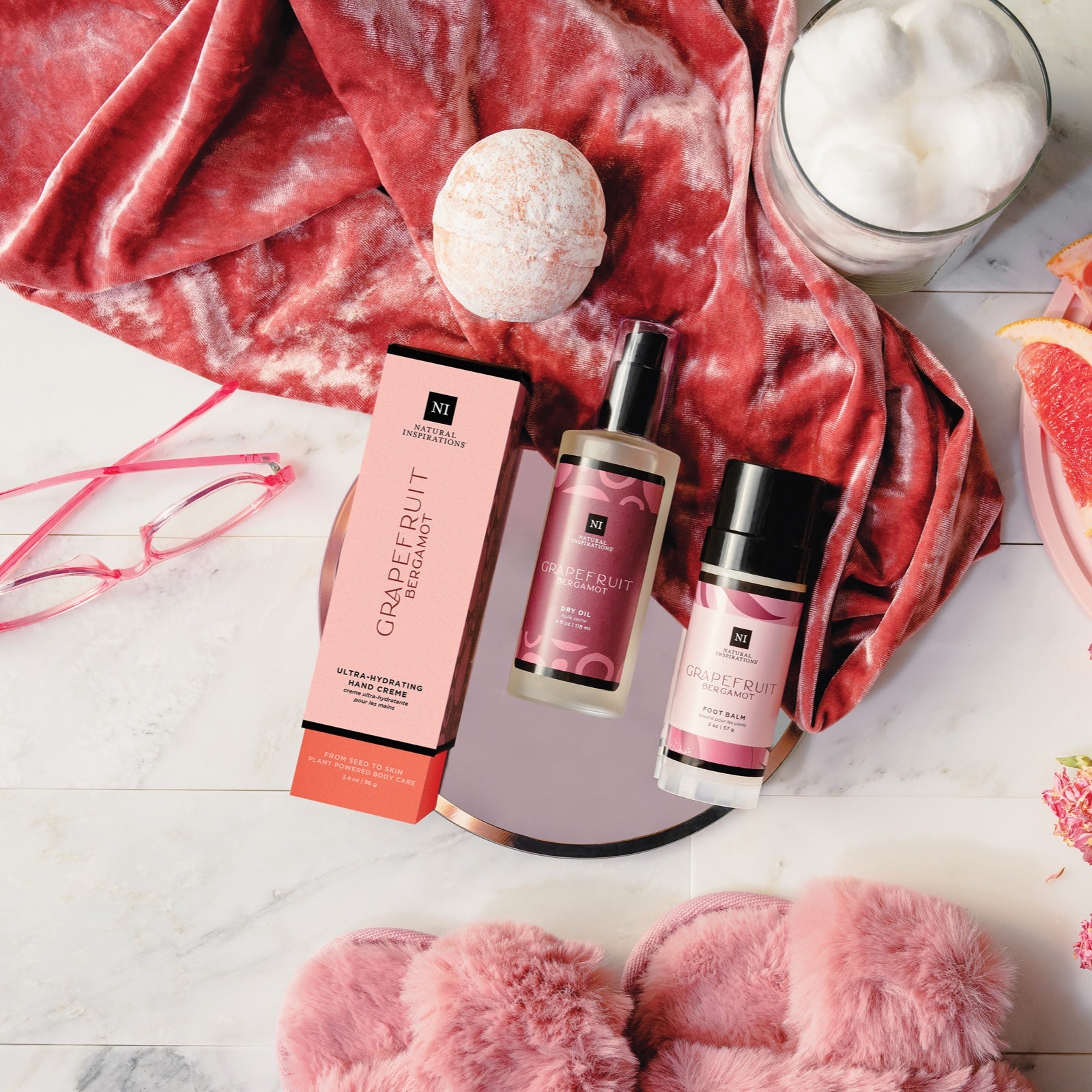 overhead view of grapefruit bergamot products in a pink bathroom setting