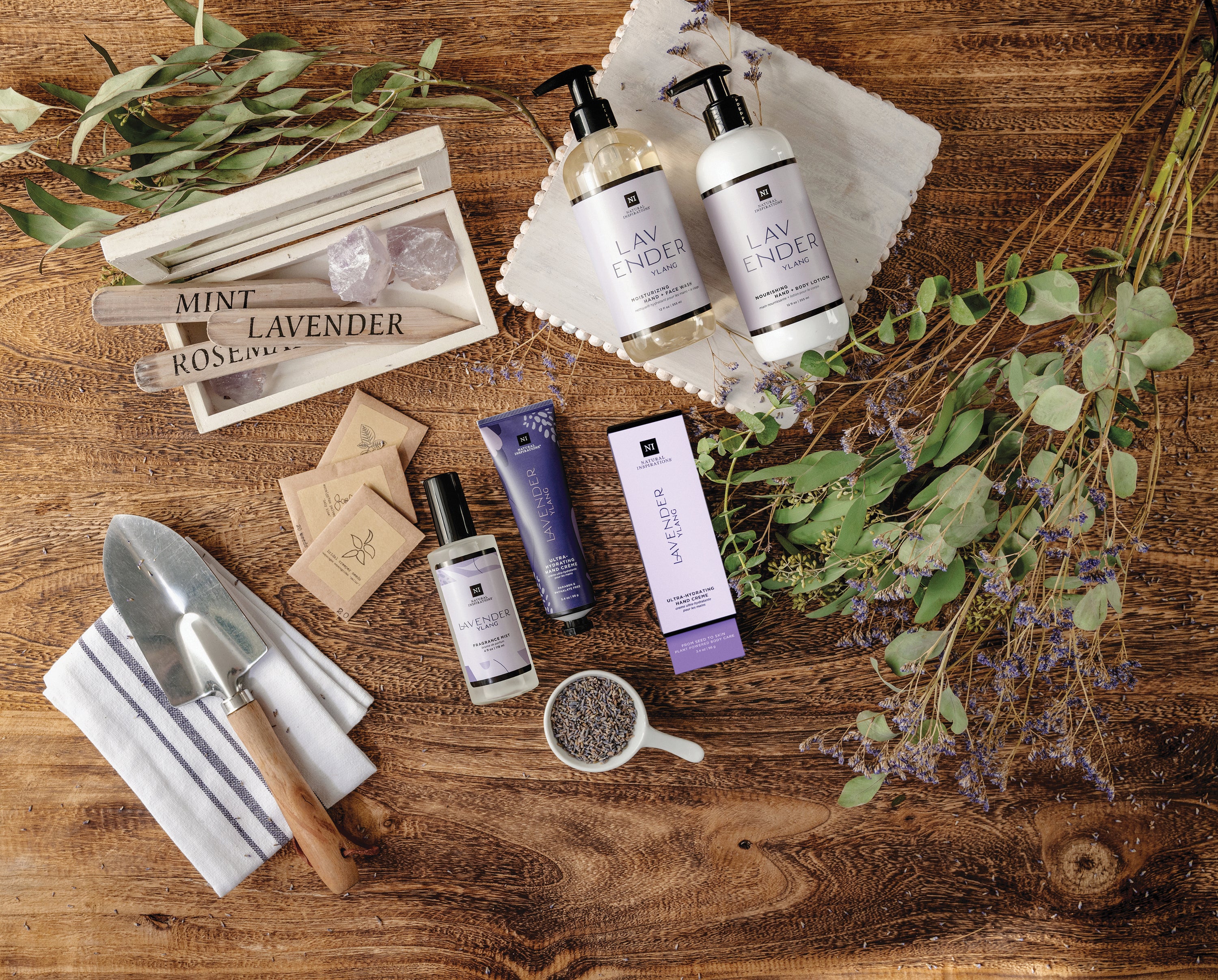overhead view of lavender ylang products in a gardening setting